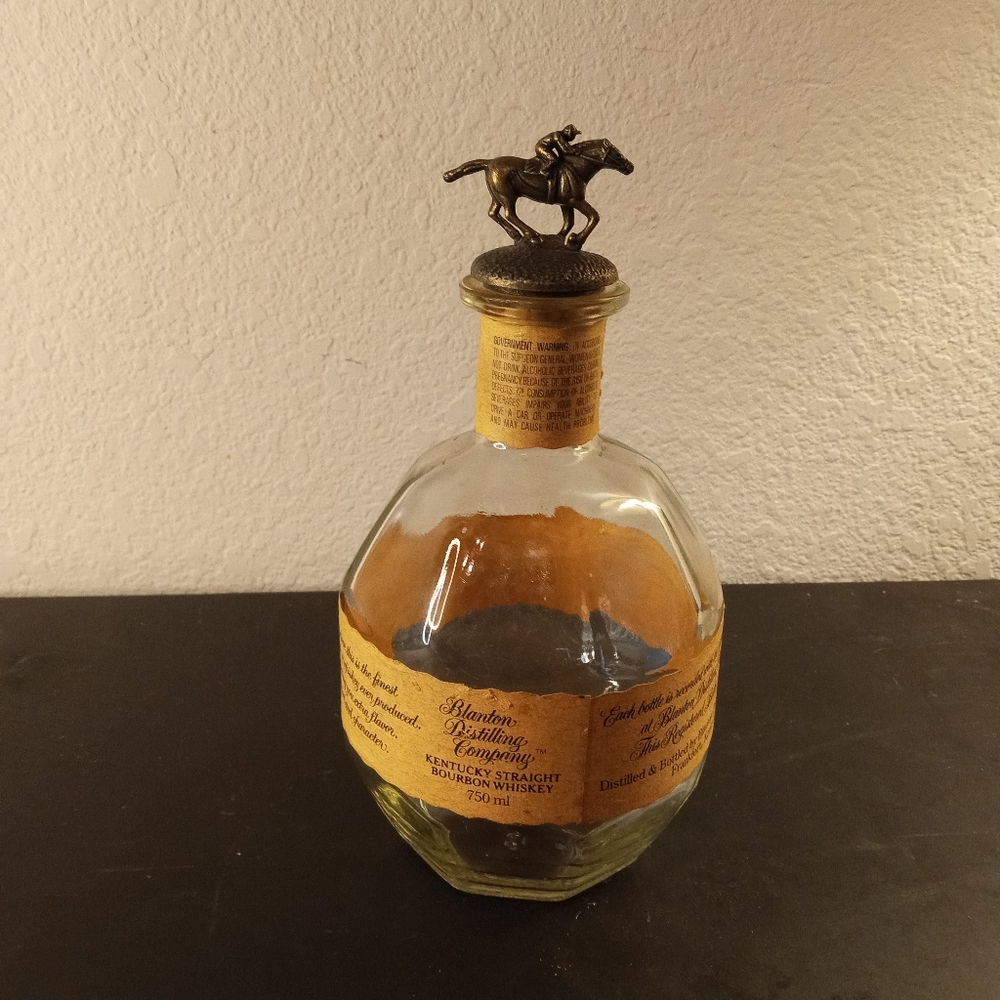 VTG Kentucky straight bourbon whiskey bottle with bronze jockey stopper.